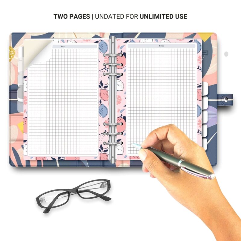 Hand holding a pen over the A5 Grid Notes Planner Insert