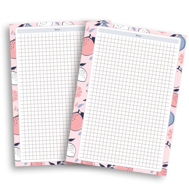 A5 Grid Notes Planner Insert on a wooden desk with a pen