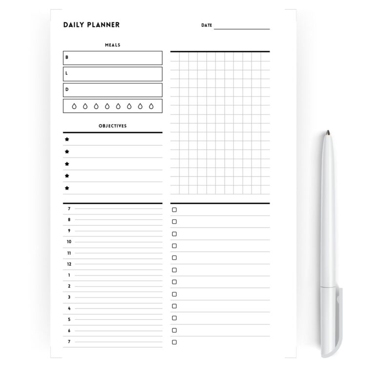 A hand writing in the schedule section of the A5 daily planner.