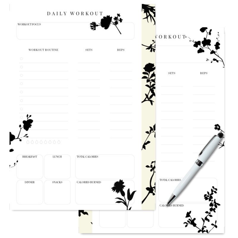 Open A5 Daily Workout Planner on a gym mat with weights.