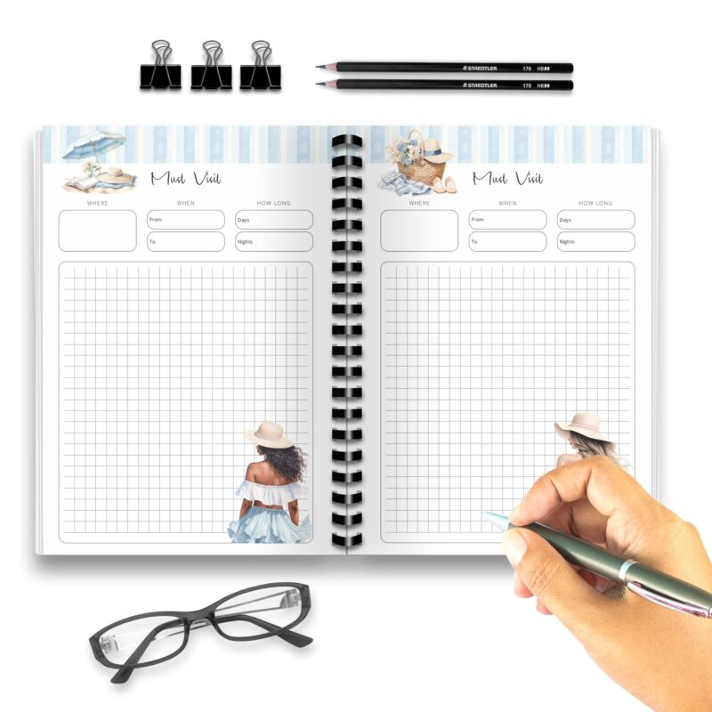 A5 beach travel planner laid on sandy background