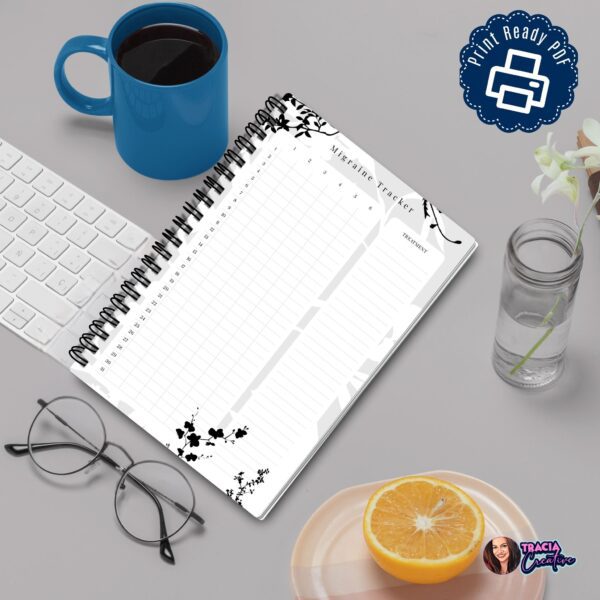 A5 Migraine Tracker printable laid out on desk